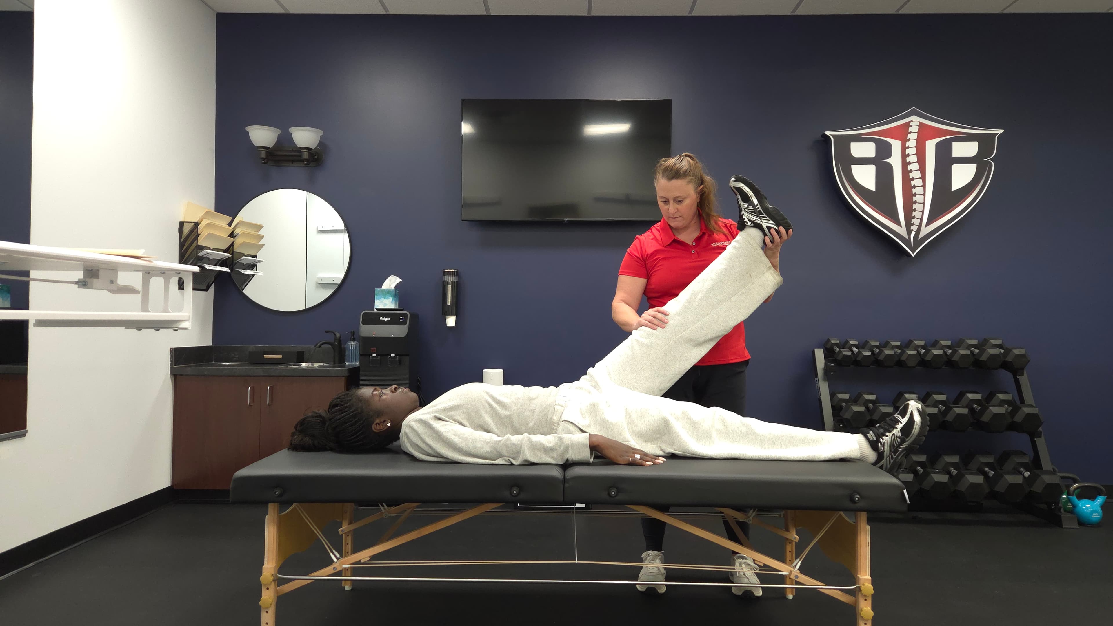 Dr. Jessica Staples guiding a patient through a leg rehabilitation exercise